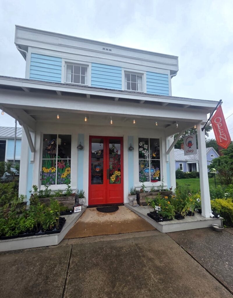 The outside of Chirp store in Ashland, cute blue house with a red door