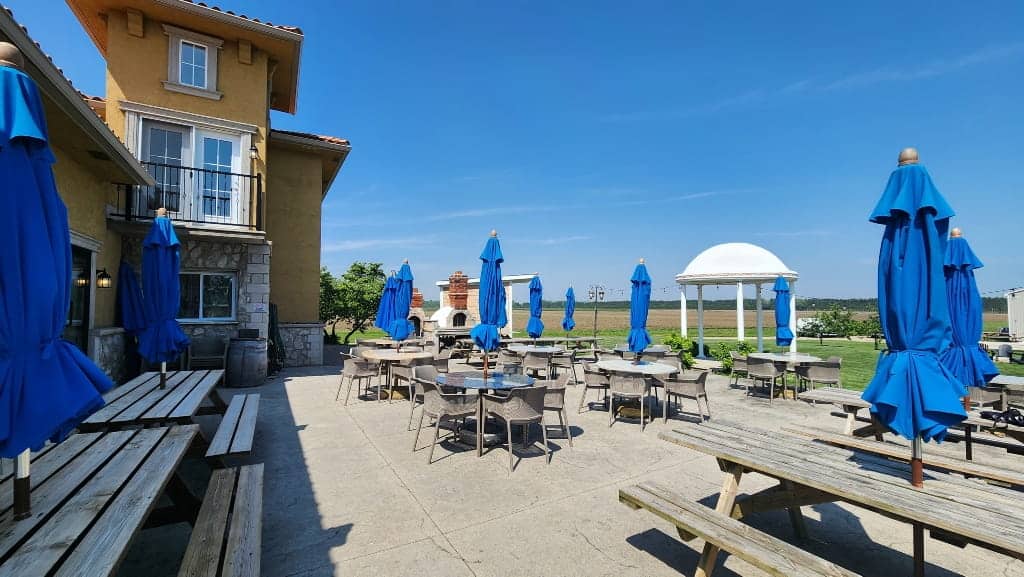 Paglione Estate Winery patio, blue sun umbrellas, picnic benches, Windsor-Essex Wineries