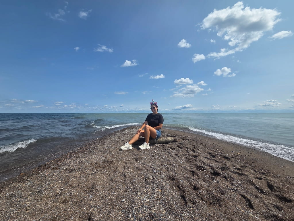 Me in Point Pelee National Park, a girl in a unicorn head band posing at the Tip of Point Pelee National Park