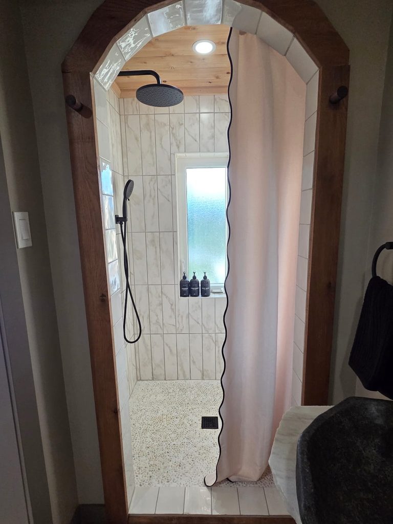 A shower with a shower curtain and a shower head, The Burrow Airbnb Review